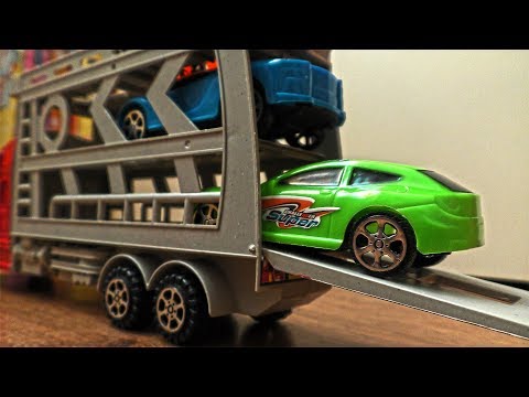 Plastic Toy Cars Being Carried By Transportation Vehicles