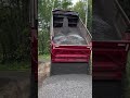 Dump truck tailgating material down steep driveway