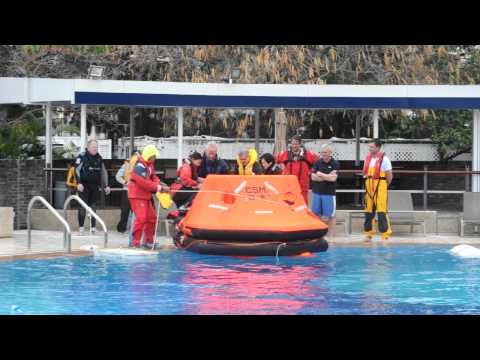 Safety at Sea Course in the Club Pool - inflating the liferaft