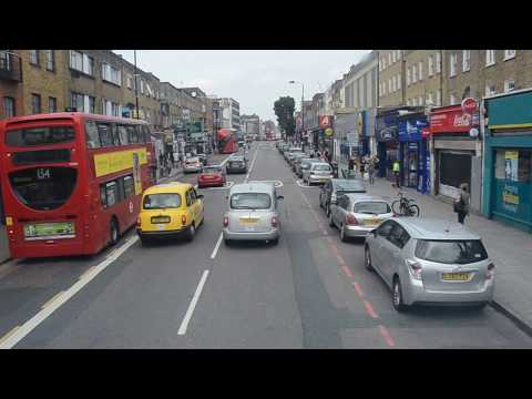 Travelling on a double-decker bus in London, Britain