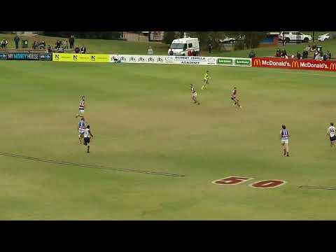 Central's Isaya McKenzie kicks a long running goal - Macca's League