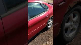 How to unlock a 2001 Ford Taurus that has died with doors locked and only starter key.