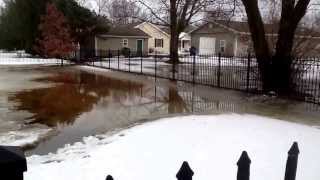 preview picture of video 'Snow melt in Heyworth, IL on 02/20/2014. Created a canal using the snow as the channel to drain yard'