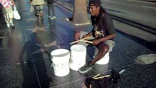 Smiling bucket drummer in Hollywood
