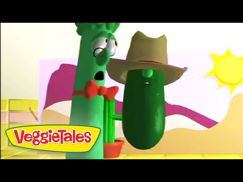 Two anthropomorphic green vegetables from VeggieTales, a tall cucumber with glasses and a shorter cucumber wearing a wide-brimmed hat, standing together on a bright, cartoon desert set with the VeggieTales logo in the corner.