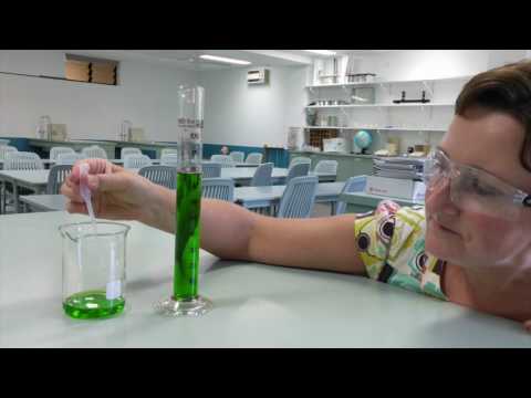 Measuring liquid in a measuring laboratory cylinder