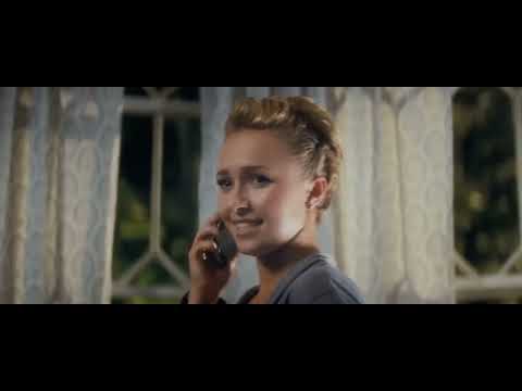 Official Scream 4 trailer frame with Ghostface and flashing blue-red lights outside a house