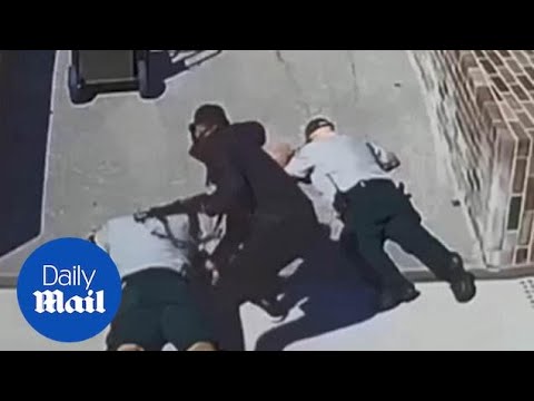 Masked man armed with a rifle robs cash truck guards