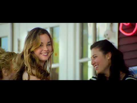 Trailer shot of reunited leads in workshop; needle-drop space for Americana cut