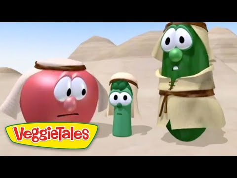 Three VeggieTales characters in desert robes stand with worried expressions, sandy dunes and pyramids in the background.