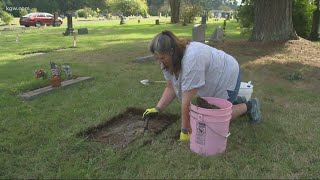 Woman cleaning every headstone in cemetery