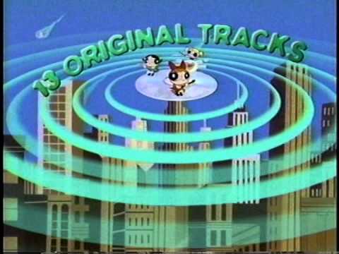 Close-up from the Heroes & Villains promo showing The Powerpuff Girls flying over Townsville