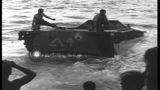 LVT (Landing Vehicle, Tracked) pulled aboard US LST (Landing Ship, Tank) off the ...HD Stock Footage