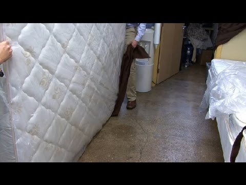 Part of a video titled How to Carry a Queen-Size Mattress : Mattresses - YouTube