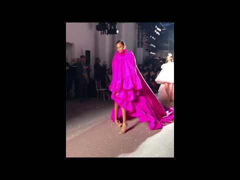 Model Annibelis Baez trips and removes her shoes during Giambattista Valli Haute Couture Spring 2019