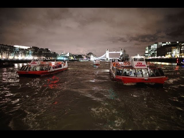 Two City Cruise boats on River Thames city on either side
