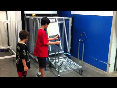 Part of a video titled IKEA Auto-Feed Flat Pack Shopping Cart Machine - YouTube