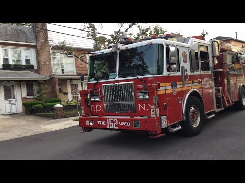 FDNY Tower Ladder 152 taking up from a small garage fire