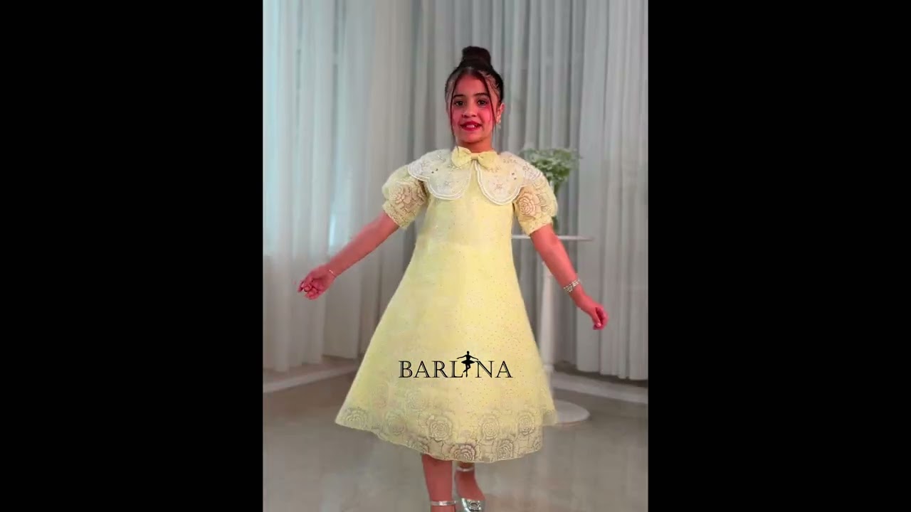 A yellow girl's dress with elegant and sophisticated details - year 1