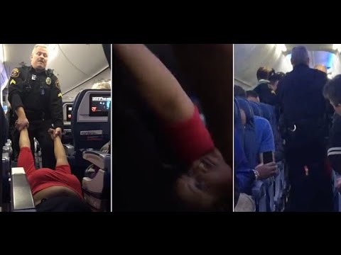 Shocking moment a woman was physically dragged off a Delta flight by two cops.