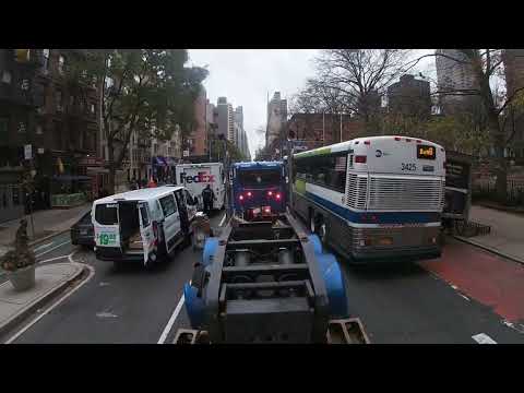 Large excavator transported through Manhattan. Cat 335 navigating traffic on a lowboy