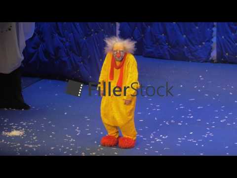 On snow show of Slava Polunin acts the clown in a yellow suit