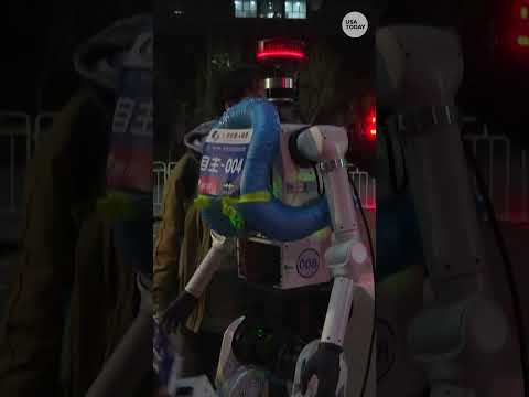 Humanoid robots race through the streets of Beijing in preparation for marathon