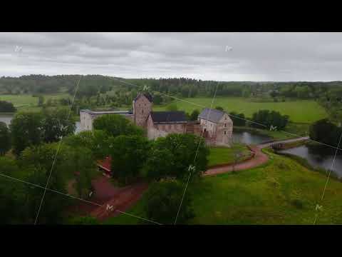 Kastelholm Castle, located on a small island in a river, showcases medieval architecture surrounded