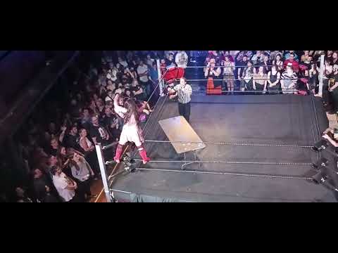 Su Yung's foot gets dangerously caught in the corner as Edith Surreal DDTs her through a table!!