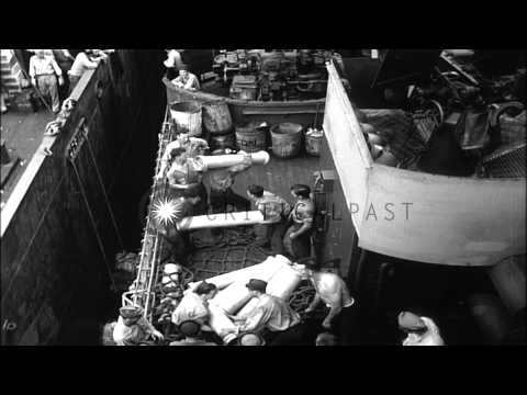 Men load, carry and pass ammunition powder cans aboard USS Birmingham in the Paci...HD Stock Footage