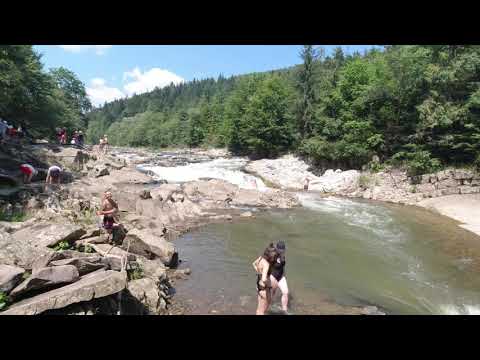 Mizunski waterfalls, Ukrainian Carpathians. Swimming in waterfall. Mountain river beach.