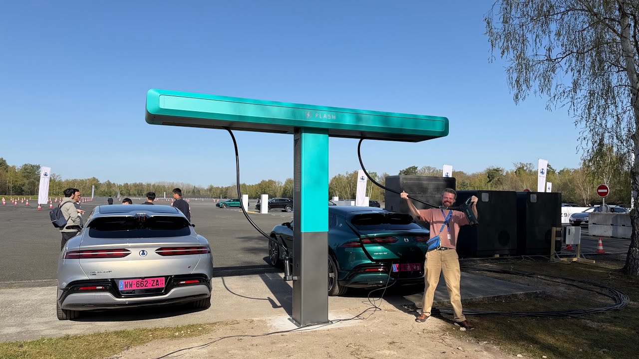 electricfelix filming the Denza flash charging system at its European launch event, with crowd watching the charge session live under a tent