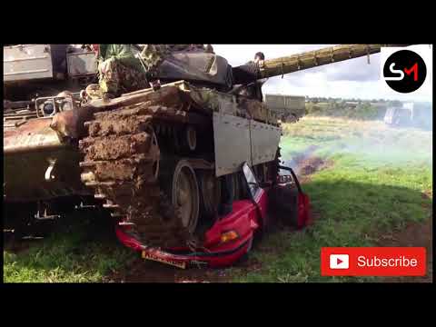 Tanks, dozer and dumpers are crushing cars.