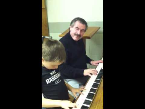 Elijah playing piano at church