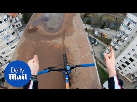 Daredevil cyclist climbs railway to carry out bike stunts - Daily Mail