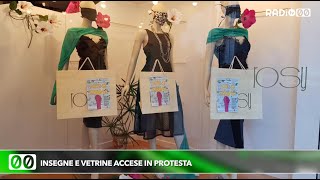 Insegne e vetrine accese in protesta