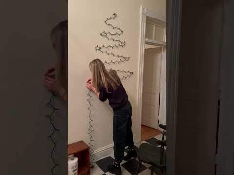 a Christmas tree with command hooks and Christmas lights #christmas #christmastree #christmasdecor