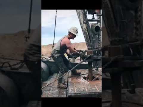 Oil rig workers throwing the chain