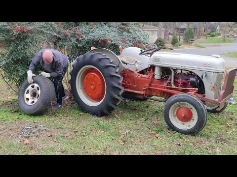 Ford 2N Tractor pulls a bush