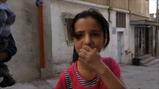 Sitting on the Curb in a Refugee Camp