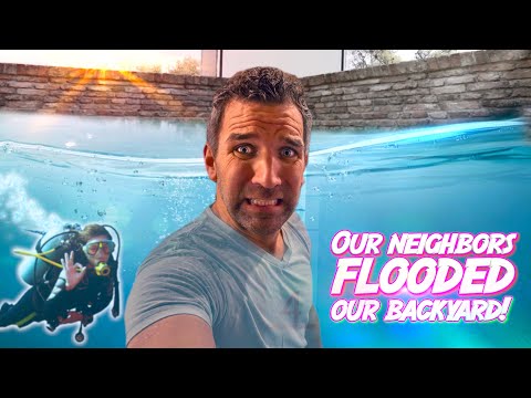 Man takes a selfie by a flooded backyard pool; scuba diver visible underwater on the left; large pink caption reads 'Our neighbors flooded our backyard!'