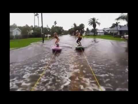 Extreme couple surf down STREETS flooded during Hurricane Hermine