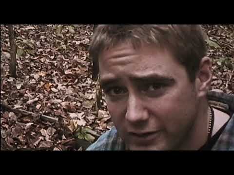 Trailer shot: flashlight beam over tree bark; handheld camera jitter