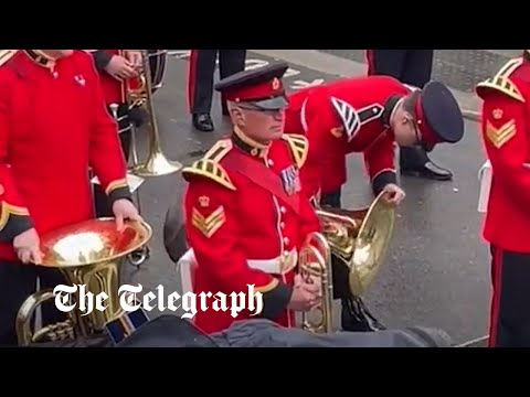 King's Coronation: Moment soldier empties tuba of rain as weather fails to dampen spirits