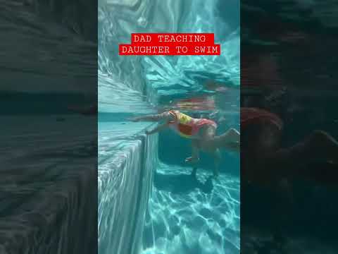 DAD TEACHING HIS DAUGHTER TO SWIM