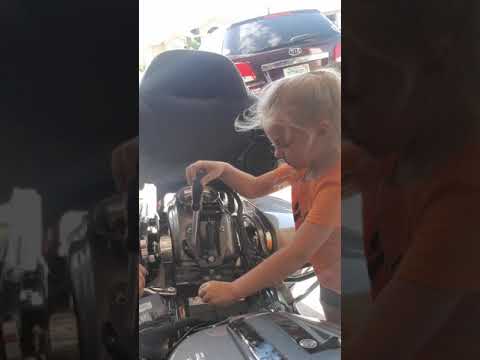 5 year old girl changes Harley-davidson battery