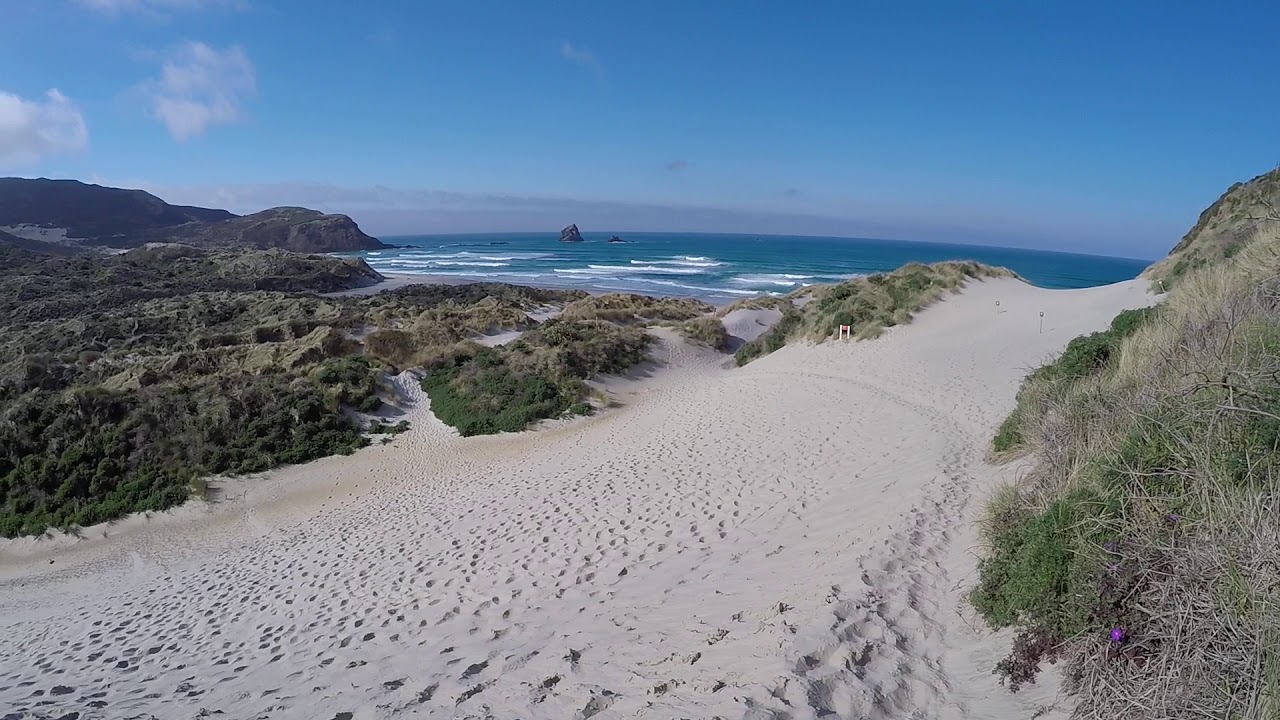 Embark on a short hike to Sand Fly Bay beach
