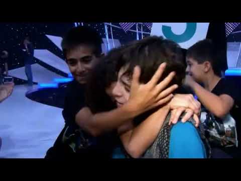 Trailer montage: arena LED wall, host rehearsals, kids peeking from the wings during the final