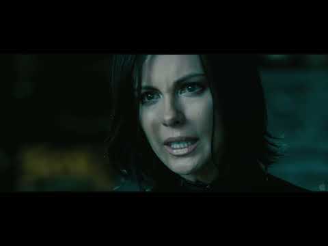 Underworld: Awakening trailer still — Selene breaches a lab window as metallic pulses build