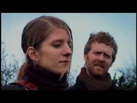 Once (2007) trailer still — Glen Hansard and Markéta Irglová on a Dublin street with a battered guitar case